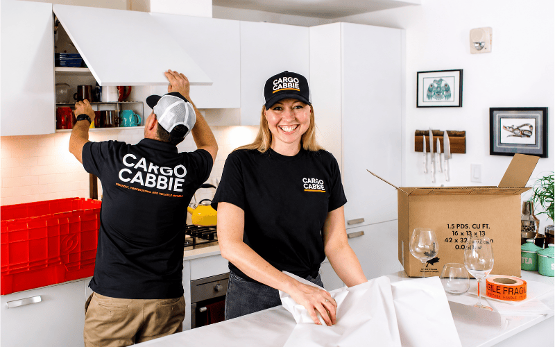 CARGO CABBIE packers wrapping glassware and packing kitchen contents in a Toronto home